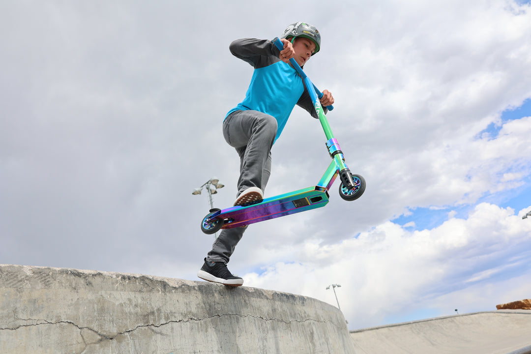 Child riding a GOTRAX ST PRO 300 Stunt Scooter for Kids at a Skatepark