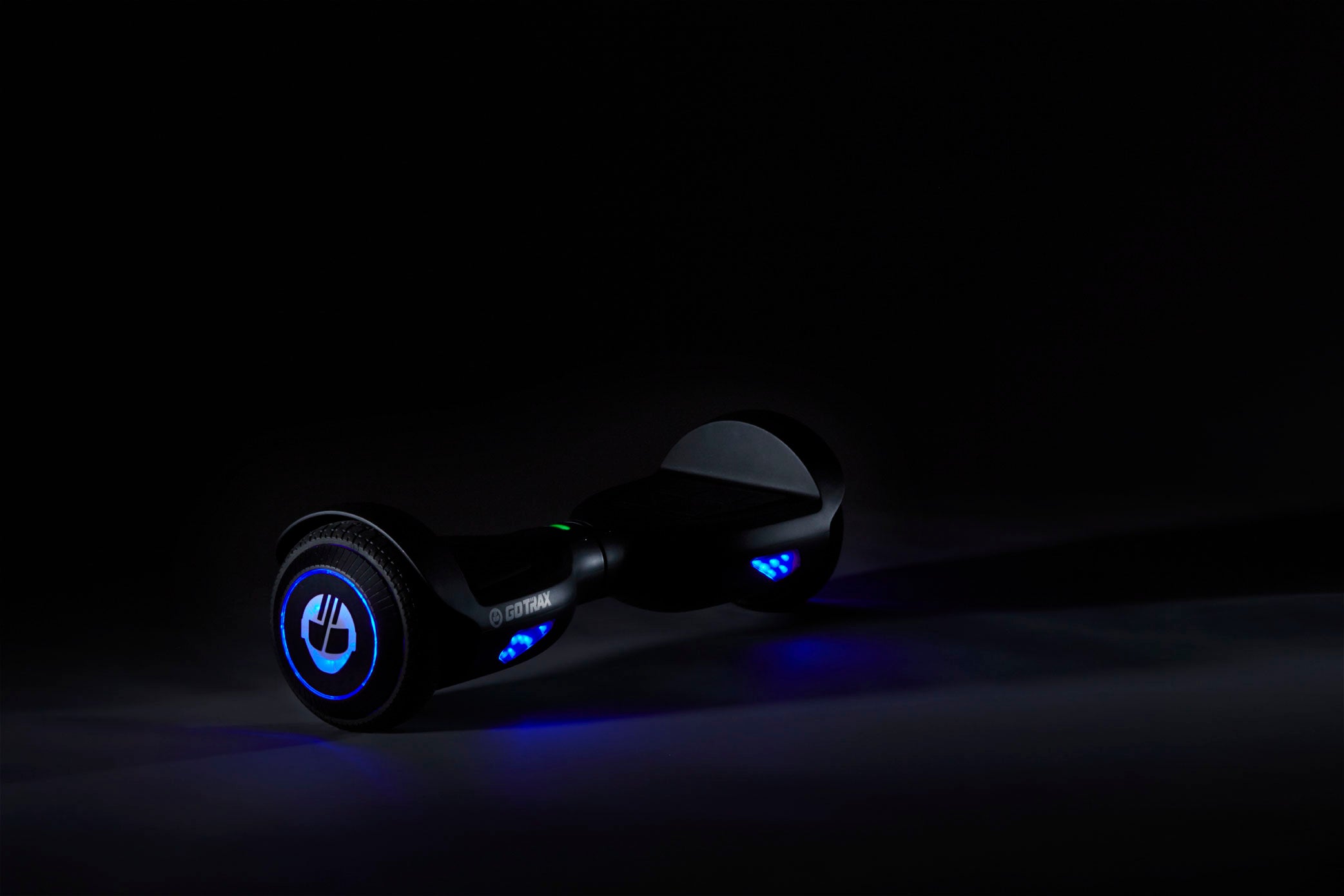 GOTRAX Black Edge LED Hoverboard for Kids in the Dark with LED's lit up. 
