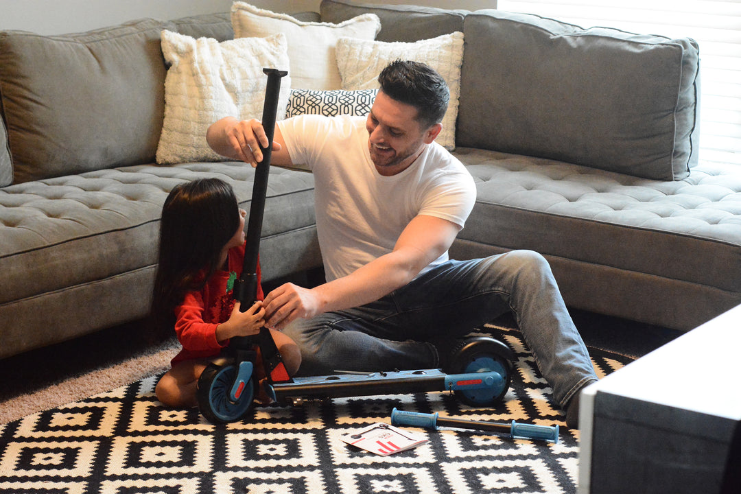 Father and Daughter putting a GOTRAX GKS Electric Scooter for Kids together.