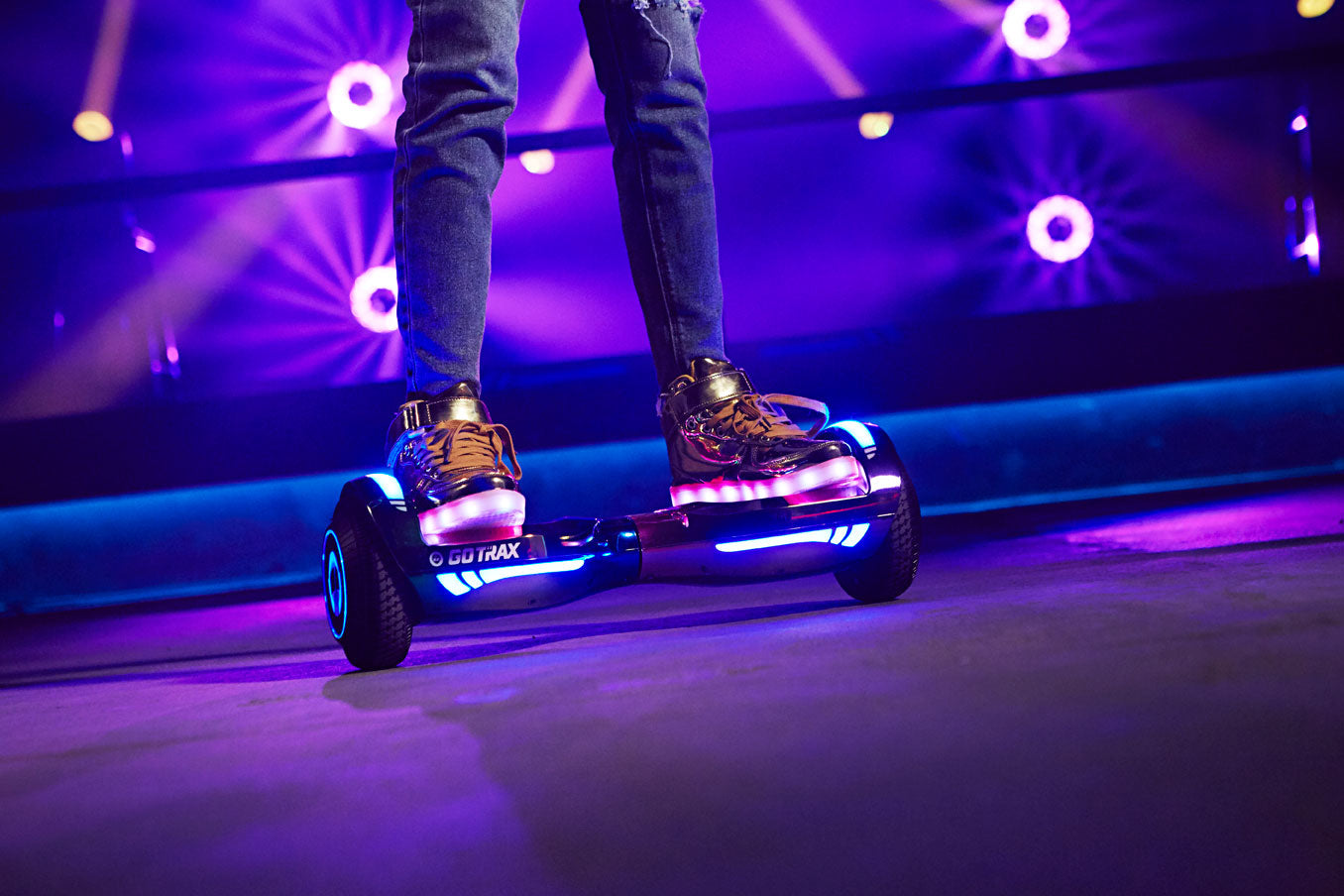 Child riding GOTRAX Rose Gold Bluetooth Hoverboard with LEDs